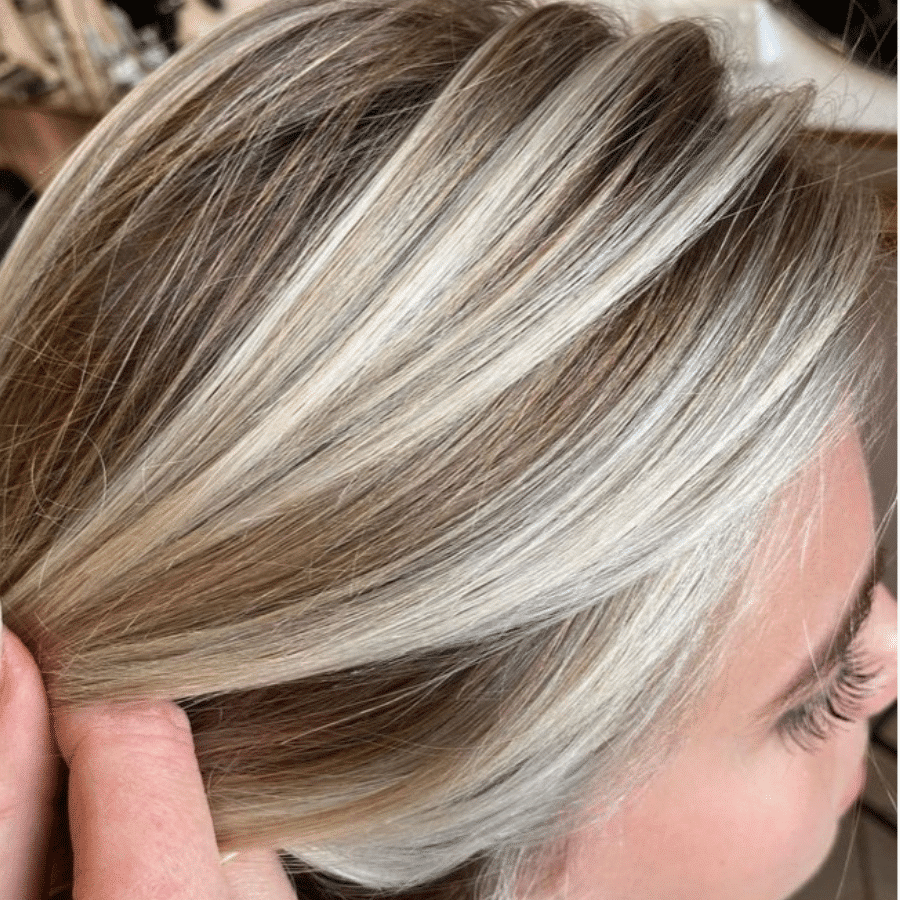 Hair pull back close to face to show highlights after using ultra blonde shampoo