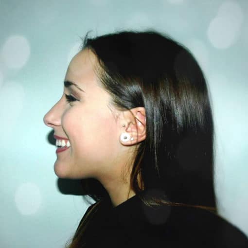 Girl with very dark hair, happy. Side profile