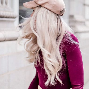 Blonde lady pale pink cap and a red top