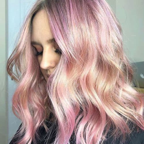 multidimensional pink tones throughout long hair only a small portion of the face showing