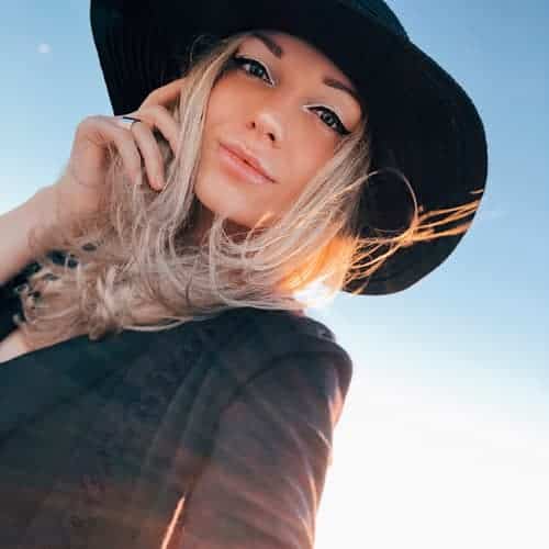 Blonde girl with black wide rim hat