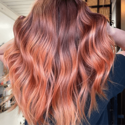 Girl with long curly hair coloured with Just Peachy Shampoo